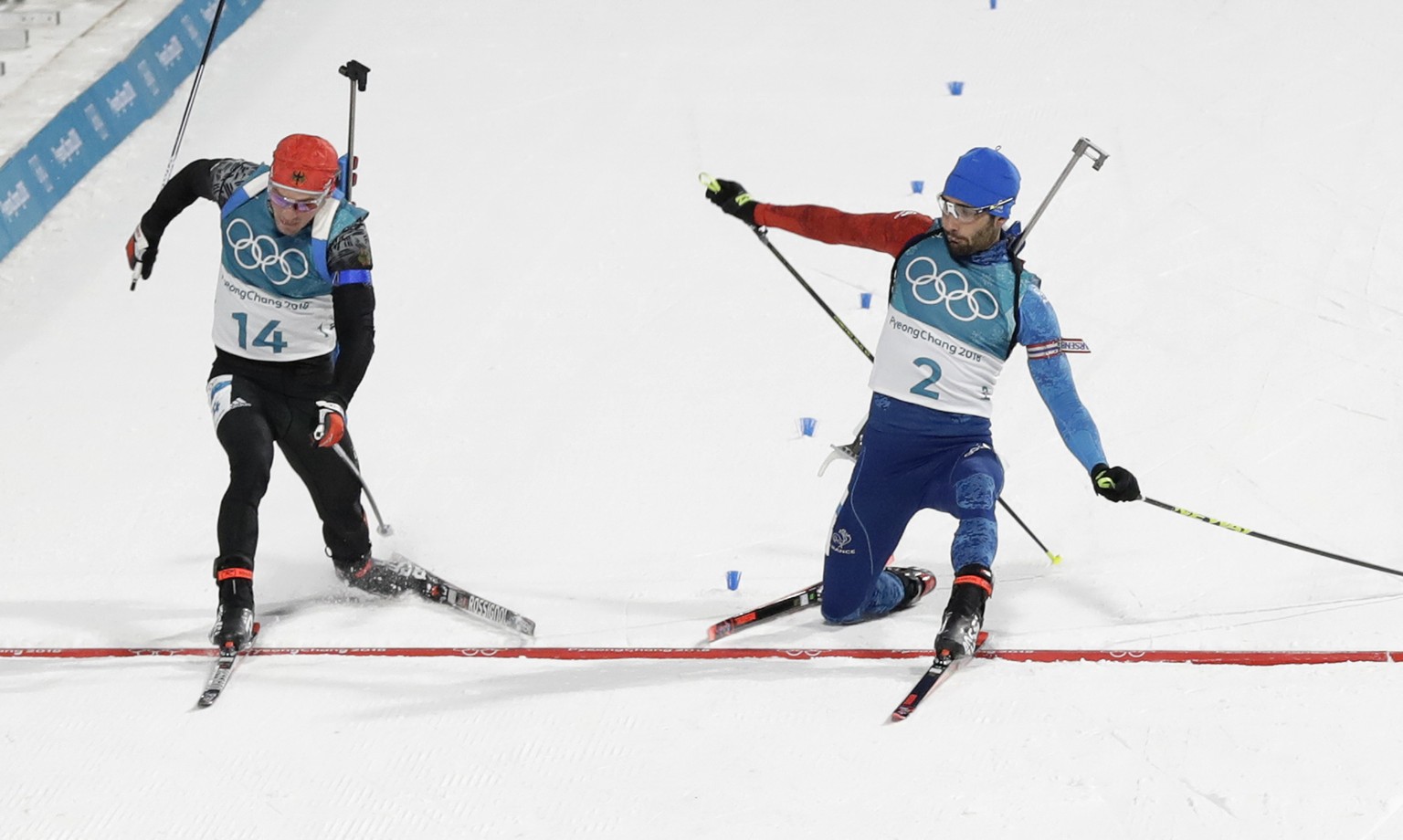 Simon Schempp, of Germany, left, and Martin Fourcade, of France, right, cross the finish line during the men&#039;s 15-kilometer mass start biathlon at the 2018 Winter Olympics in Pyeongchang, South K ...