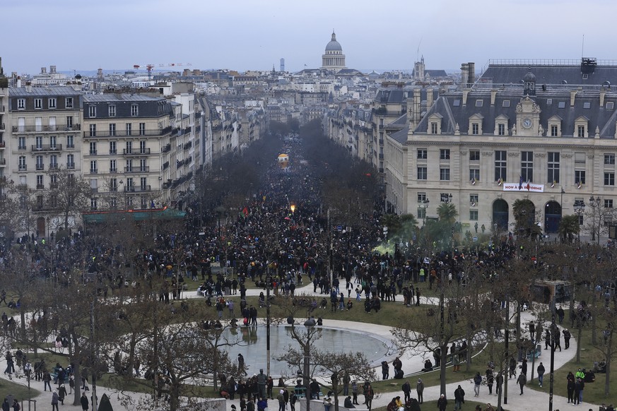Protesters march during a demonstration, Tuesday, March 7, 2023 in Paris. Hundreds of thousands of demonstrators across France took part Tuesday in a new round of protests and strikes against the gove ...