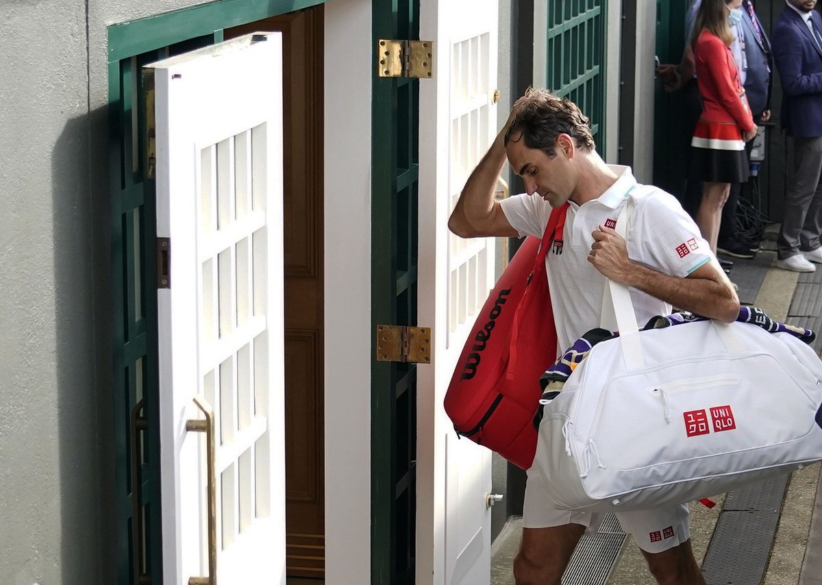 Switzerland's Roger Federer leaves the court after being defeated by Poland's Hubert Hurkacz during the men's singles quarterfinals match on day nine of the Wimbledon Tennis Championshi ...