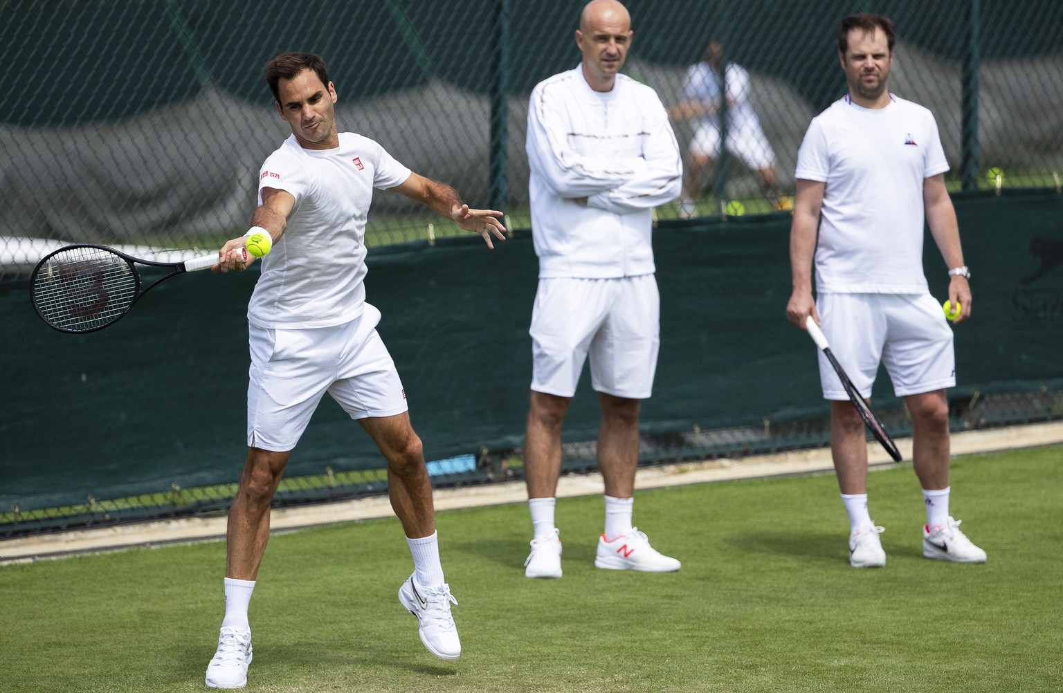 epa07675099 Roger Federer (L) of Switzerland and his coaches Ivan Ljubicic (C) and Severin Luethi (R) attend a training session at the All England Lawn Tennis Championships in Wimbledon, London, Brita ...