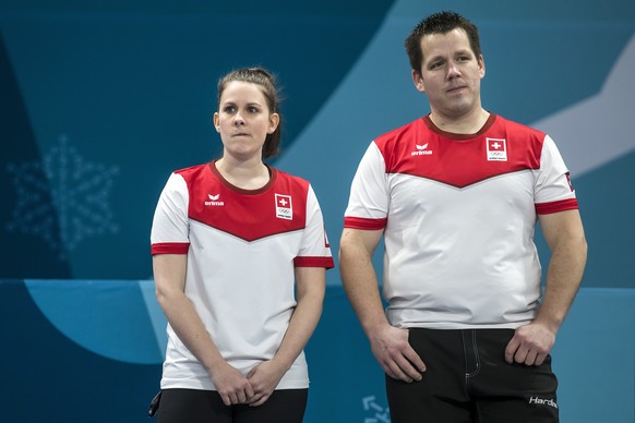 Silver medal winner Jenny Perret and Martin Rios of Switzerland, from left, during the flower ceremony after the Mixed Doubles Curling final game between Switzerland and Canada during the XXIII Winter ...