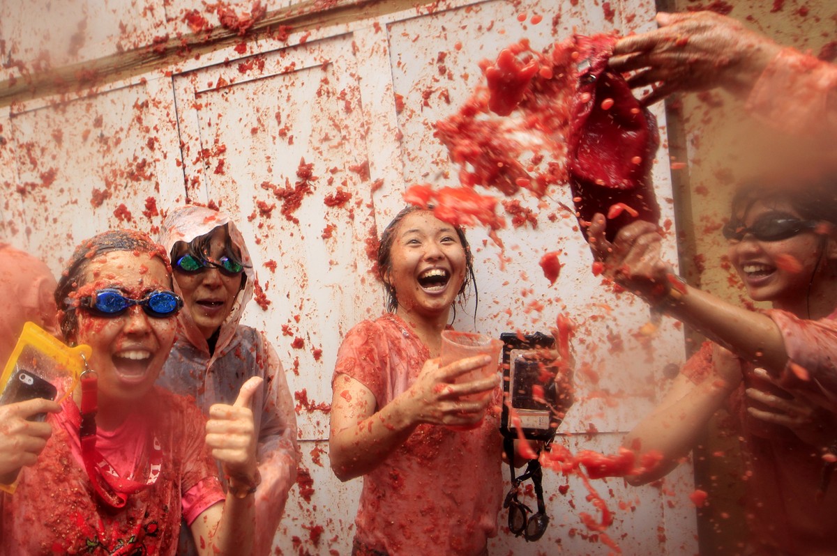 Revelers enjoy as they throw tomatoes at each other, during the annual "Tomatina", tomato fight fiesta, in the village of Bunol, 50 kilometers outside Valencia, Spain, Wednesday, Aug. 30, 20 ...