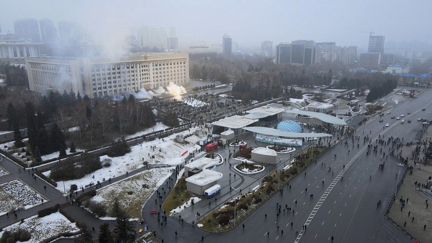 Smoke rises from the city hall building during a protest in Almaty, Kazakhstan, Wednesday, Jan. 5, 2022. News outlets in Kazakhstan are reporting that demonstrators protesting rising fuel prices broke ...