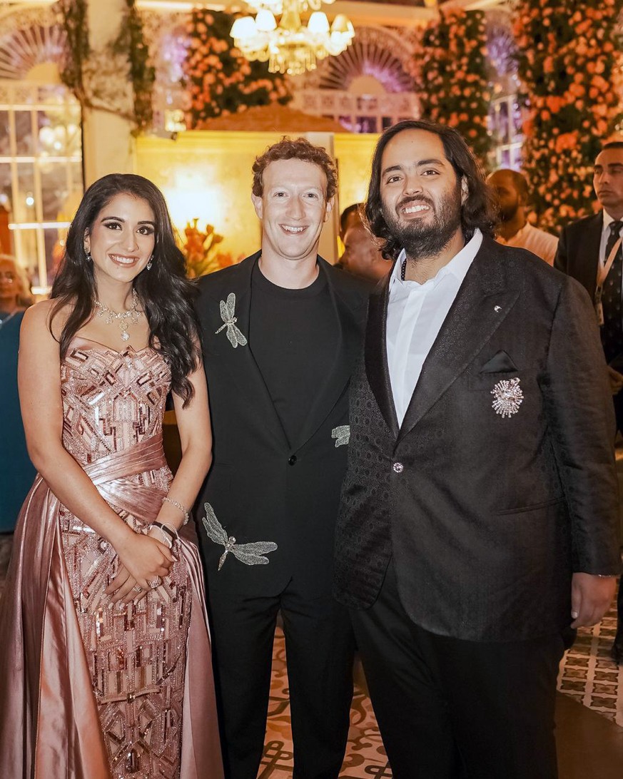 This photo released by the Reliance group shows Mark Zuckerberg, center, posing for a photo with billionaire industrialist Mukesh Ambani's son, Anant Ambani, right, and Radhika Merchant…