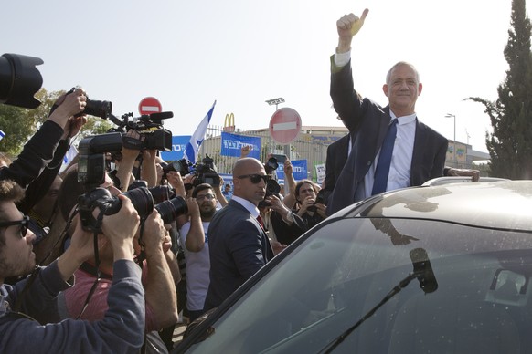 Blue and White party leader Benny Gantz gives thumb up to his supporters after casting vote during Israel&#039;s general elections in Rosh Haayin, Israel, Tuesday, April 9, 2019. (AP Photo/Sebastian S ...