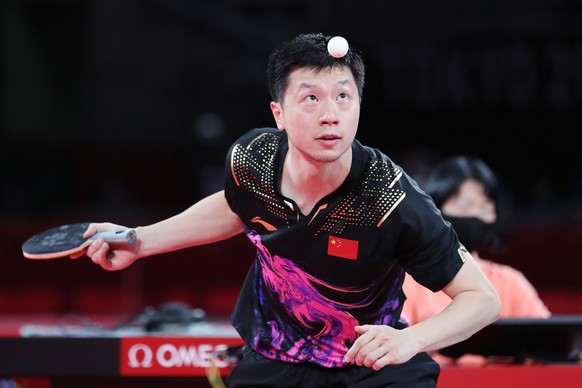 epa09380157 Ma Long of China in action against Fan Zhendong of China (not pictured) during the Table Tennis Men&#039;s Singles Gold Medal Match of the Tokyo 2020 Olympic Games at the Tokyo Metropolita ...