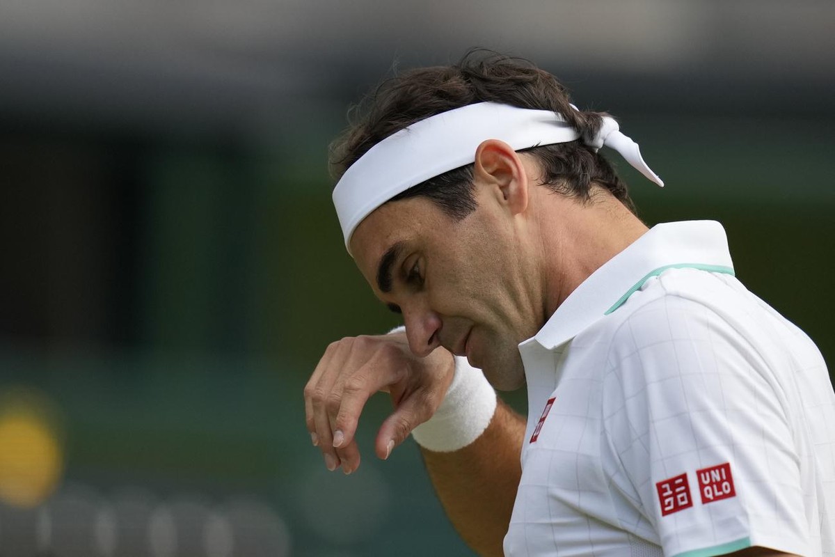 Switzerland's Roger Federer wipes his brow during the men's singles quarterfinals match against Poland's Hubert Hurkacz on day nine of the Wimbledon Tennis Championships in London, Wedn ...