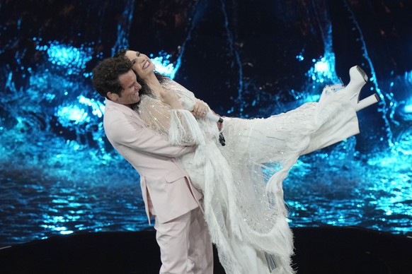 Hosts of the Eurovision Song Contest Laura Pausini, right, and Mika perform during the second semi final at the Eurovision Song Contest in Turin, Italy, Thursday, May 12, 2022. (AP Photo/Luca Bruno)