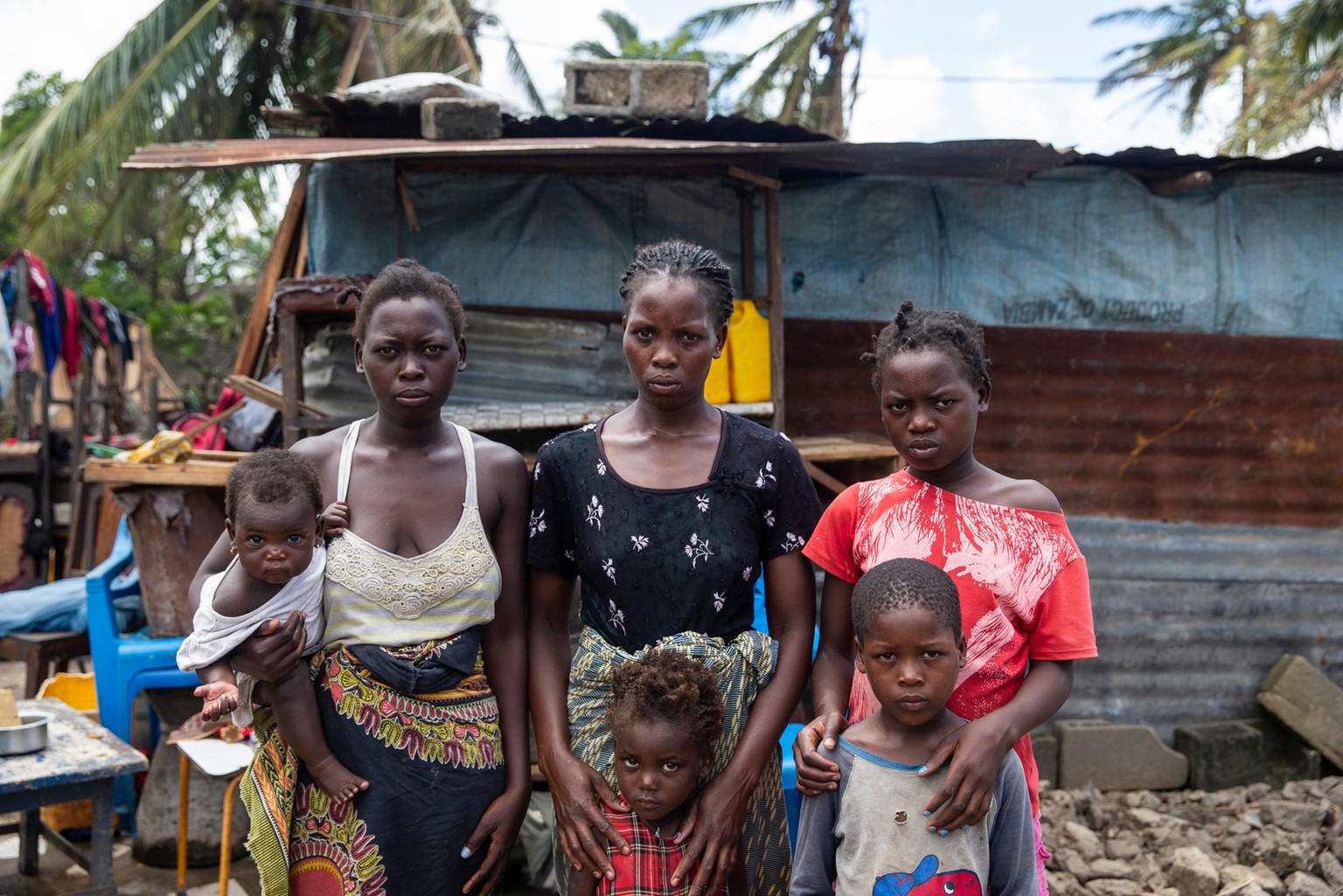 On 21 March 2019 in Mozambique, (back row) Anna Francesco holds her daughter Tina Fransesco, Clara Fransesco, Tija Fransesco, (bottom row) Regina Francesco and Emmanuel Francesco stands in front of a  ...