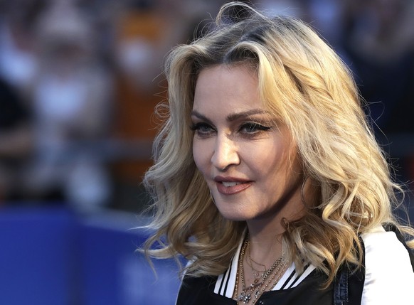 ADDS THAT MADONNA HAS DENIED THAT SHE IS SEEKING TO ADOPT TWO MORE CHILDREN - FILE - In this Sept. 15, 2016, file photo, musician Madonna poses for photographers upon arrival at the world premiere of  ...