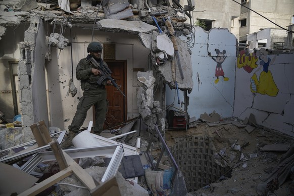 An Israeli soldier stands at the entrance of a tunnel where the military says six Israeli hostages were recently killed by Hamas militants in the southern Gaza Strip on Friday, Sept. 13, 2024. (AP Pho ...