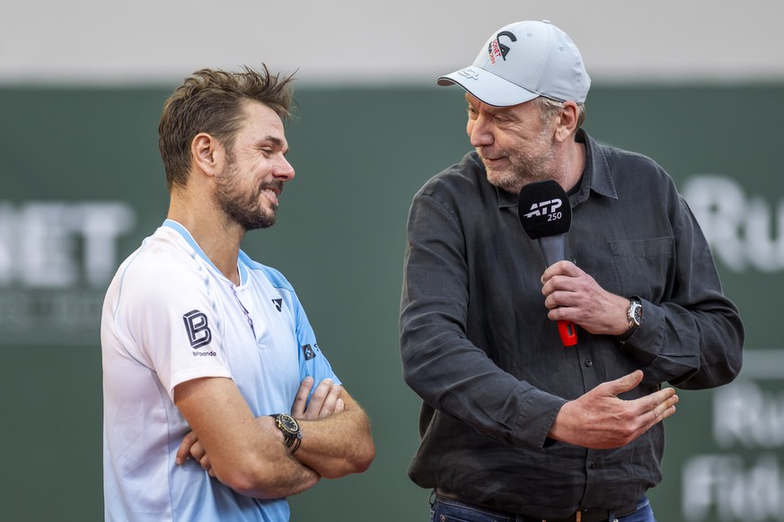 Former tennis player Marc Rosset, right, Sport director of Geneva Open speaks witch Stan Wawrinka, left, from Switzerland, bids farewell to the tournament where he will no longer play, during their ro ...