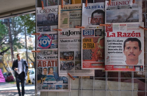 Newspapers hang on display for sale in Mexico City, Monday, Feb. 23, 2026, a day after the Mexican army killed Jalisco New Generation Cartel leader Nemesio Oseguera Cervantes, known as "El Mencho ...