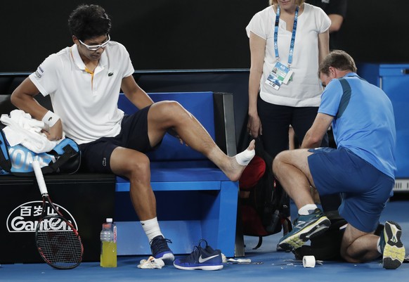 South Korea&#039;s Hyeon Chung receives treatment from a trainer during his semifinal against Switzerland&#039;s Roger Federer at the Australian Open tennis championships in Melbourne, Australia, Frid ...