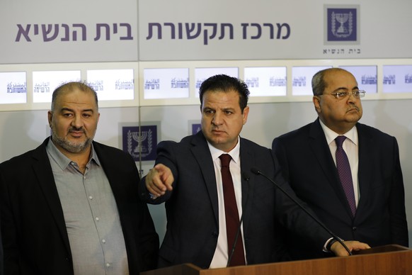Members of the Joint List Ayman Odeh, center, speaks to the press in the presence of Ahmad Tibi, right, and Mansour Abbas following their consulting meeting with Israeli President Reuven Rivlin, in Je ...
