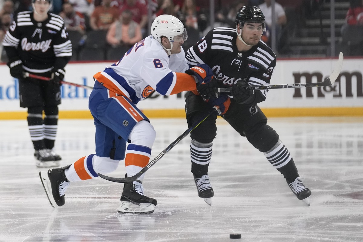 New York Islanders' Ryan Pulock (6) and New Jersey Devils' Timo Meier (28) compete for the puck during the second period of an NHL hockey game in Newark, N.J., Monday, April 15, 2024. (AP Ph ...
