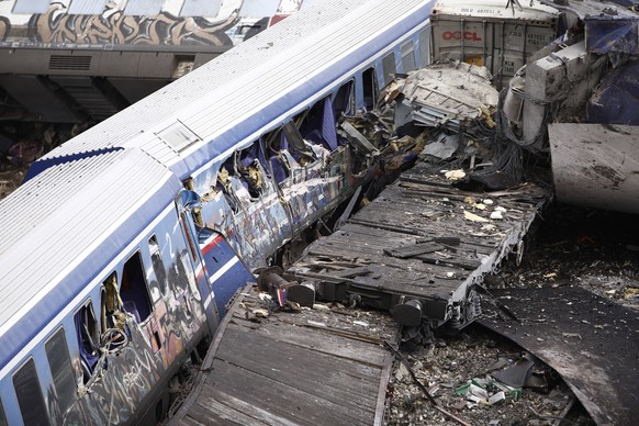 Debris of trains lie on the rail lines after a collision in Tempe, about 376 kilometres (235 miles) north of Athens, near Larissa city, Greece, Wednesday, March 1, 2023. A passenger train carrying hun ...