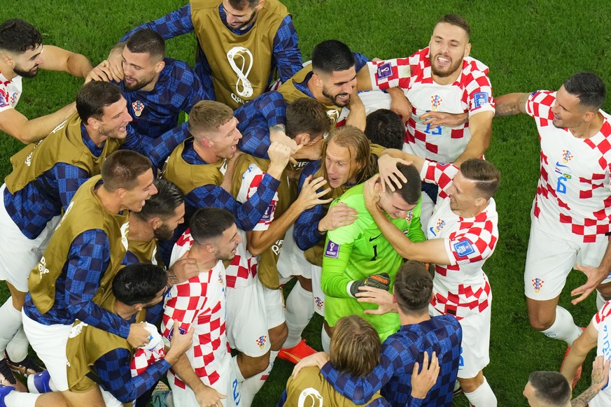 Croatia's players celebrate winning the World Cup quarterfinal soccer match between Croatia and Brazil, at the Education City Stadium in Al Rayyan, Qatar, Friday, Dec. 9, 2022. (AP Photo/Petr Dav ...