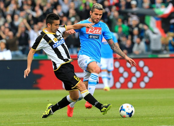 Udinese's Giampiero Pinzi, left, and Napoli's Valon Behrami fight for the ball during the Serie A soccer match between Udinese and Napoli at the Friuli Stadium in Udine, Italy, Saturday, April 19 2014 ...