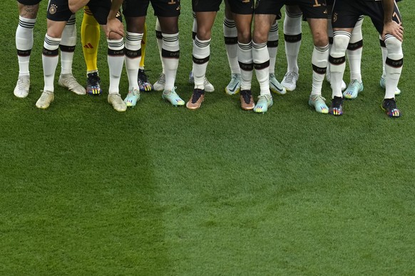 Many of Germany&#039;s soccer team players have rainbow colours on their boots as they pose for a team group before the World Cup group E soccer match between Germany and Japan, at the Khalifa Interna ...