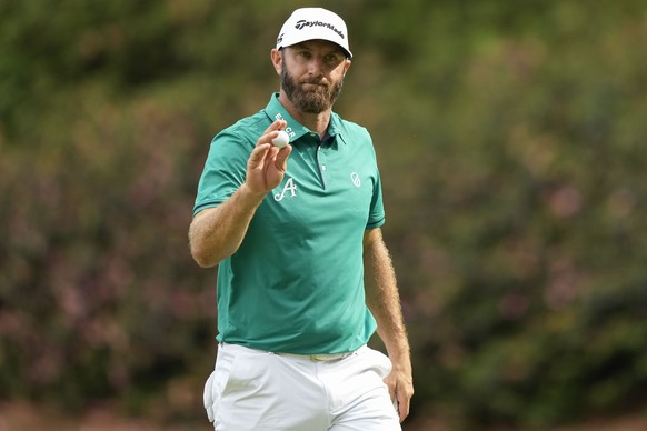 Dustin Johnson waves after his putt on the 13th hole during the first round of the Masters golf tournament at Augusta National Golf Club on Thursday, April 6, 2023, in Augusta, Ga. (AP Photo/David J.  ...