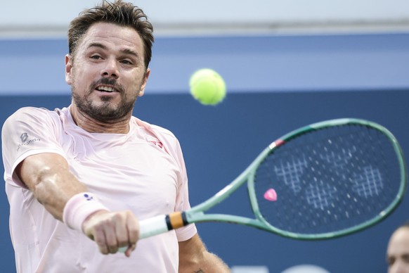 epa11567980 Stan Wawrinka of Switzerland hits a return to Mattia Bellucci of Italy (not shown) during their first round match in the US Open Tennis Championships at the USTA Billie Jean King National  ...