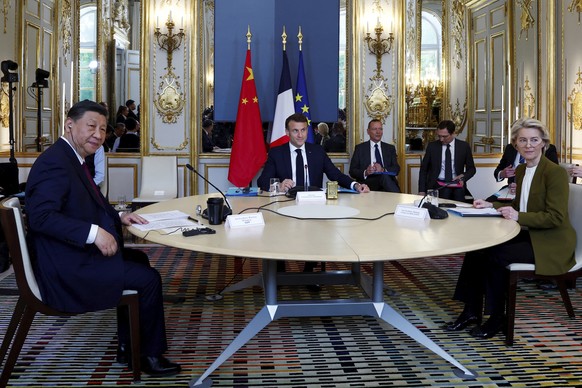 French President Emmanuel Macron, center, China&#039;s President Xi Jinping and European Commission President Ursula von der Leyen attend a trilateral meeting at the Elysee Palace as part of the Chine ...