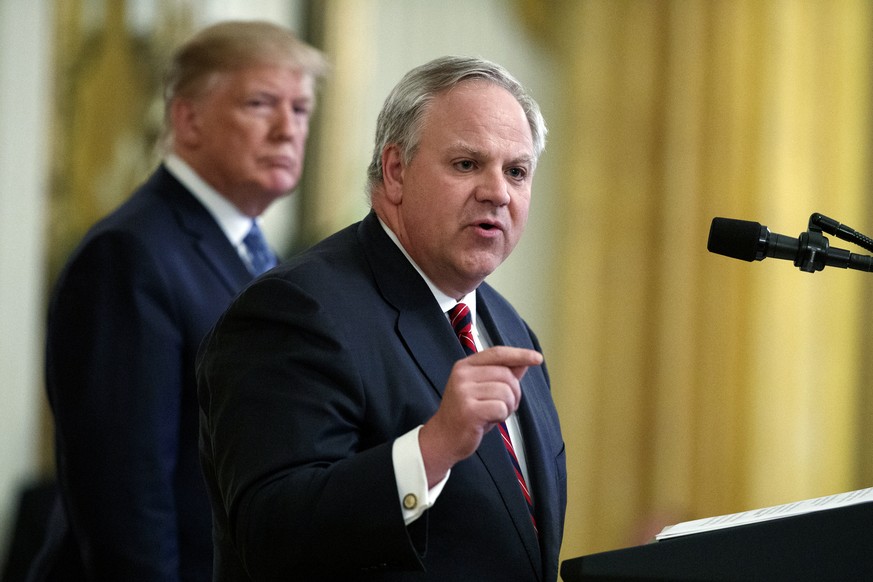 FILE - In this July 8, 2019 file photo President Donald Trump listens as Secretary of the Interior David Bernhardt speaks during an event on the environment in the East Room of the White House in Wash ...