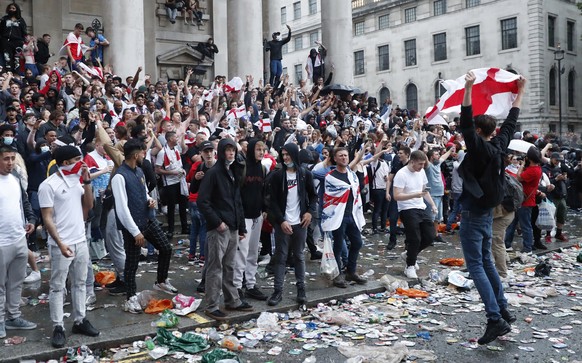 An England supporter waves a flag near Trafalgar Square in London, Sunday, July 11, 2021, during the Euro 2020 soccer championship final match between England and Italy which is being played at Wemble ...