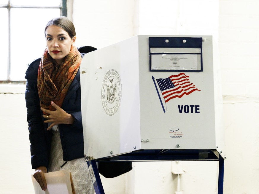 epa07146320 Alexandria Ocasio-Cortez, who is running as the Democratic nominee for New York&#039;s 14th congressional district, casts her ballots in the 2018 midterm general election at a polling site ...