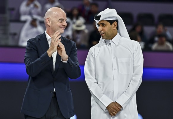 epa12740492 International Association Football Federation (FIFA) President Gianni Infantino (L) and French football club Paris Saint-Germain's Qatari president Nasser al-Khelaifi speak as they wa ...
