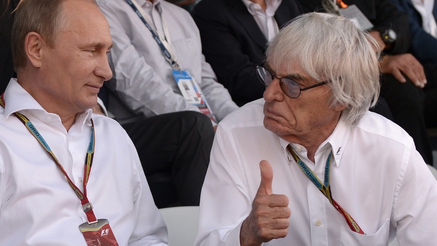 Russian President Vladimir Putin, left, and Formula One chief Bernie Ecclestone attend the Formula One Russian Grand Prix at the Sochi Autodrom Formula One circuit, in Sochi, Russia, Sunday, Oct. 12,  ...