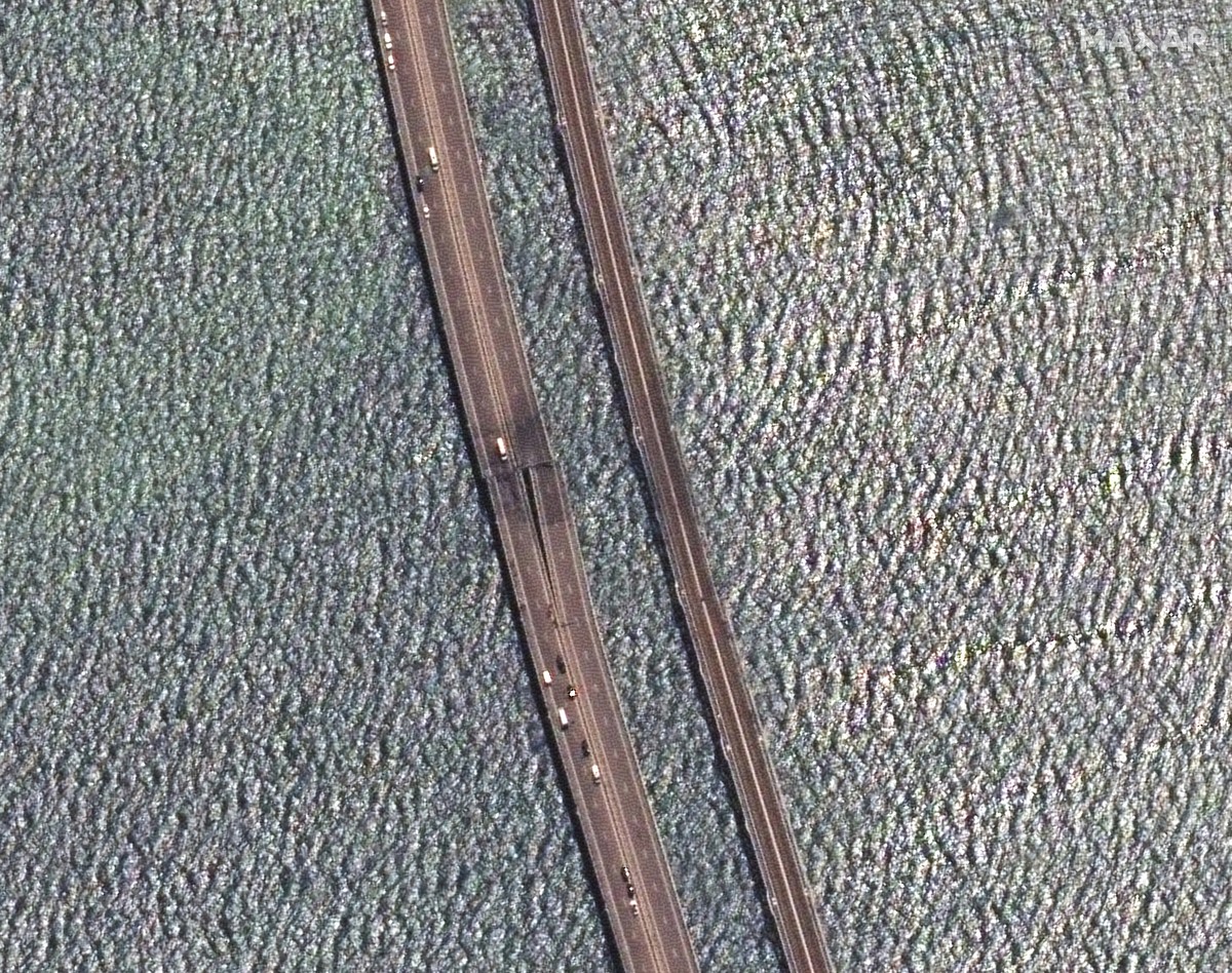 This image provided by Maxar Technologies, shows damaged parts of an automobile link of the Crimean Bridge connecting Russian mainland and Crimean peninsula over the Kerch Strait not far from Kerch, C ...