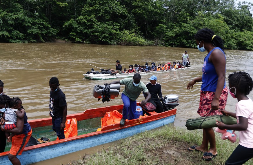 Migrants arrive in Lajas Blancas, Darien, Panama, Saturday, Oct. 23, 2021. A rising number of female migrants have reported suffering sexual abuse while crossing the treacherous Darien Gap between Col ...