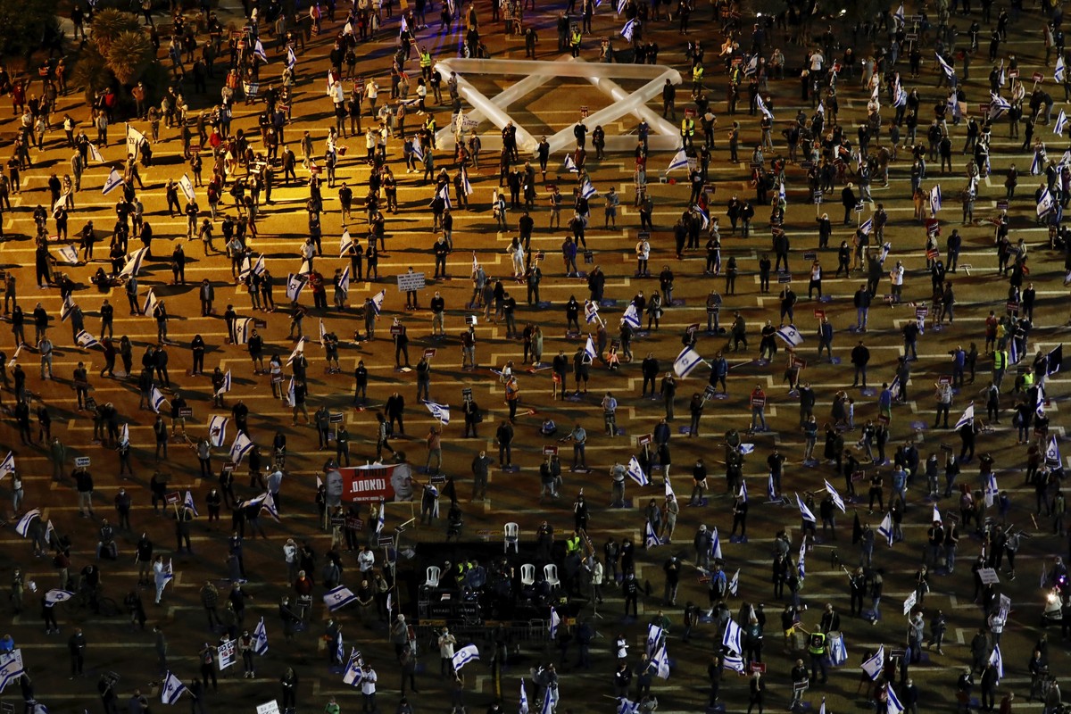 People keep social distance amid concerns over the country's coronavirus outbreak, during a protest against Prime Minister Benjamin Netanyahu and Benny Gantz and government corruption, at Rabin s ...