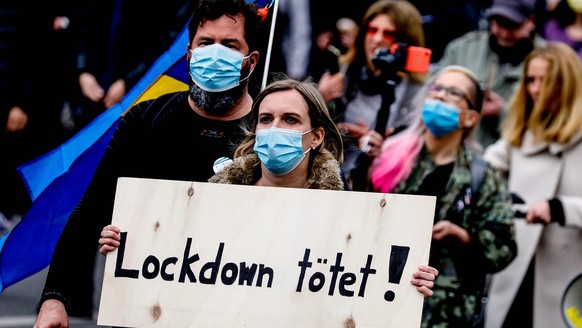 epa09171336 Protesters during demonstration against the German government Coronavirus measures, on May Day in Berlin, Germany, 01 May 2021. Labor Day, or May Day, is observed all over the world on the ...