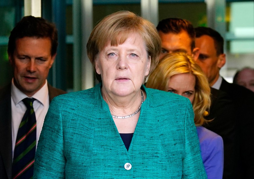 epa06806944 German Chancellor Angela Merkel leaves the Reichstag building, the seat of the German parliament Bundestag, after extraordinary separated CDU and CSU parliamentary group meetings in Berlin ...