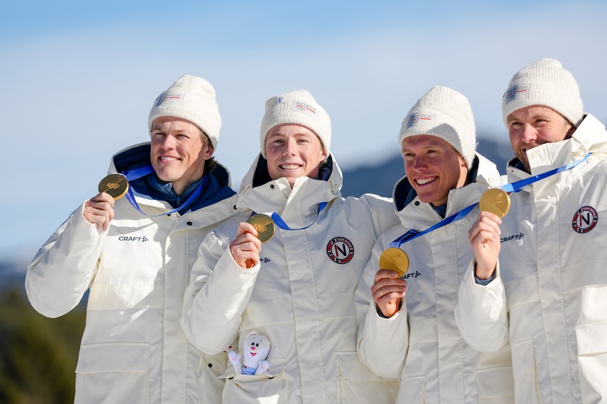 Johannes Hoesflot Klaebo, Einar Hedegart, Martin Loewstroem Nyenget and Emil Iversen, of Norway, pose on the podium after winning the gold medal in the cross country skiing men's 4 x 7.5km relay  ...