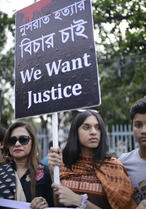 Protesters hold placards and gather to demand justice for an 18-year-old woman who was killed after she was set on fire for refusing to drop sexual harassment charges against her Islamic school&#039;s ...