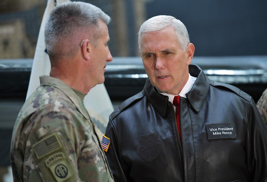 U.S. Vice President Mike Pence speaks to Gen. Nick Nicholson, commander of U.S. forces in Afghanistan, in a hangar at Bagram Air Base in Afghanistan on Thursday, Dec. 21, 2017. (Mandel Ngan/Pool via A ...