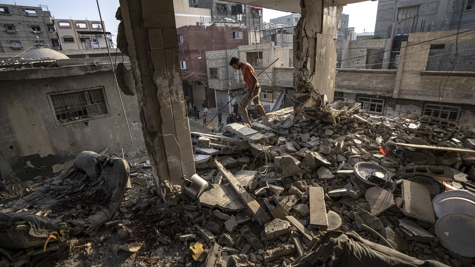 Palestinians look at the destruction after Israeli strikes on the Gaza Strip in Khan Younis, Friday, Now. 3, 2023. (AP Photo/Fatima Shbair)