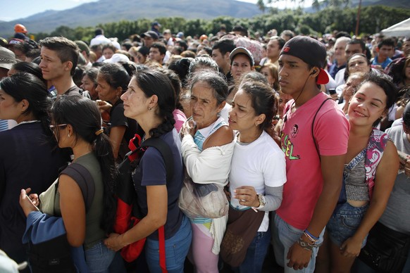 Venezuelans wait in line to cross into Colombia through the Simon Bolivar bridge in San Antonio del Tachira, Venezuela, Sunday July 17, 2016. Tens of thousands of Venezuelans crossed the border into C ...