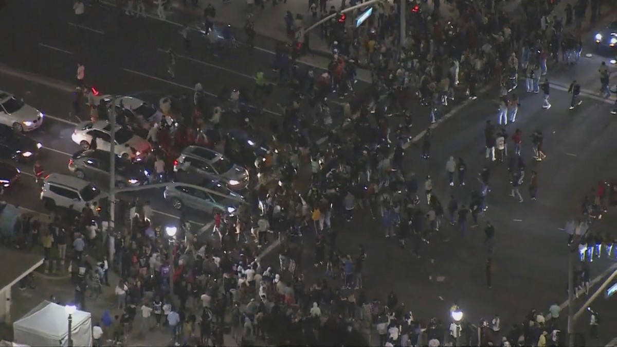 This Saturday, May 22, 2021 aerial screenshot provided by FOX 11 KTTV shows people gathered at the Huntington Beach pier in Huntington Beach, Calif. Police in Huntington Beach estimate that at least 1 ...