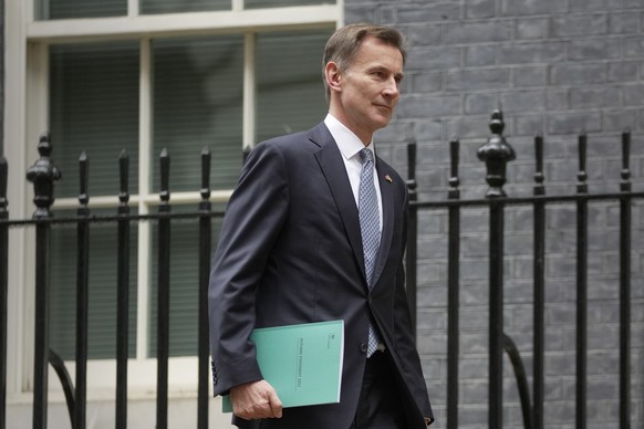 Britain's Chancellor Jeremy Hunt leaves 11 Downing Street to attend Parliament in London, Thursday, Nov. 17, 2022. Just three weeks after taking office, British Prime Minister Rishi Sunak faces the ch ...