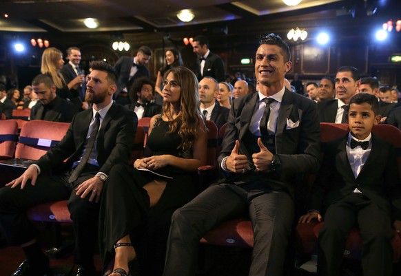 FILE - In this Monday, Oct. 23, 2017 file photo, Portuguese soccer player Christiano Ronaldo, second from right, and son Cristiano Ronaldo Jr., right, sit beside Argentinian soccer player Lionel Messi ...