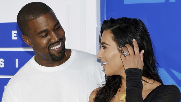 FILE - In this Aug. 28, 2016 file photo, Kanye West, left, and Kim Kardashian West arrive at the MTV Video Music Awards in New York. Armed robbers forced their way into a private Paris residence early ...