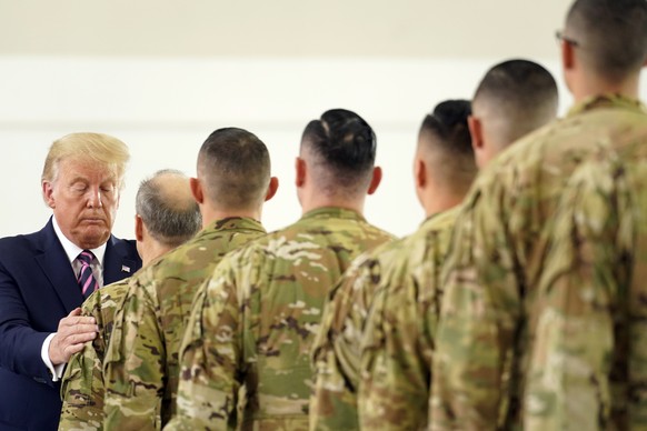 FILE - In this Sept. 14, 2020 file photo, President Donald Trump participates in a ceremony recognizing the California National Guard at Sacramento McClellan Airport, in McClellan Park, Calif., after  ...