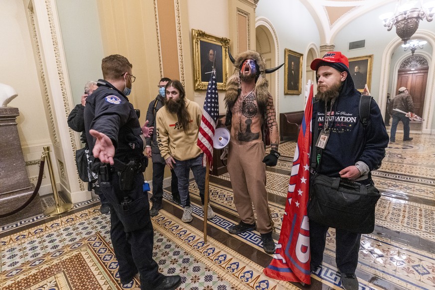 Supporters of President Donald Trump are confronted by Capitol Police officers outside the Senate Chamber inside the Capitol, Wednesday, Jan. 6, 2021 in Washington. (AP Photo/Manuel Balce Ceneta)