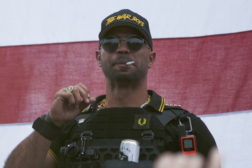 FILE - In this Sept. 26, 2020, file photo, Proud Boys leader Henry &quot;Enrique&quot; Tarrio wears a hat that says The War Boys during a rally in Portland, Ore. Police in the nation