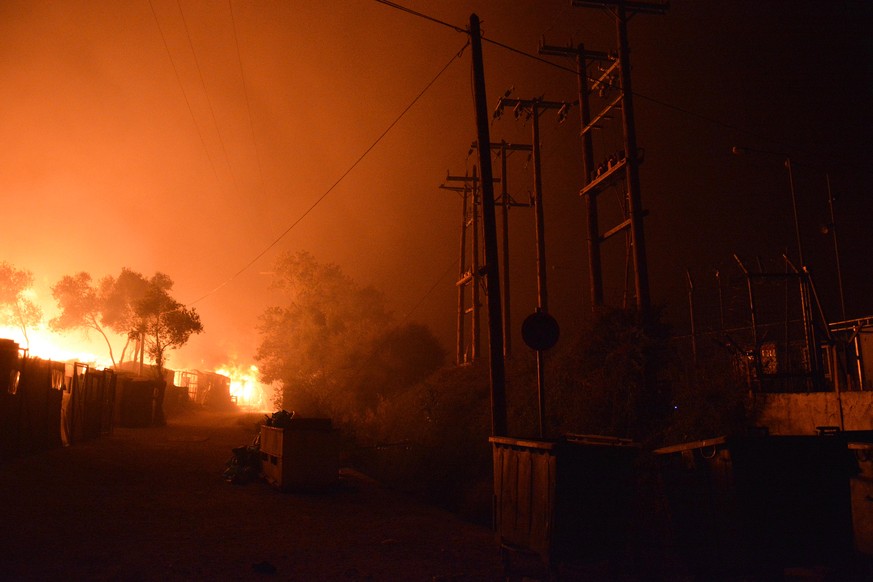 epa08655818 Flames burn in the Moria refugees camp on the island of Lesbos, Greece, 09 September 2020. According to reports, afire broke out at Moria Camp early on 09 September, after approximatley 35 ...